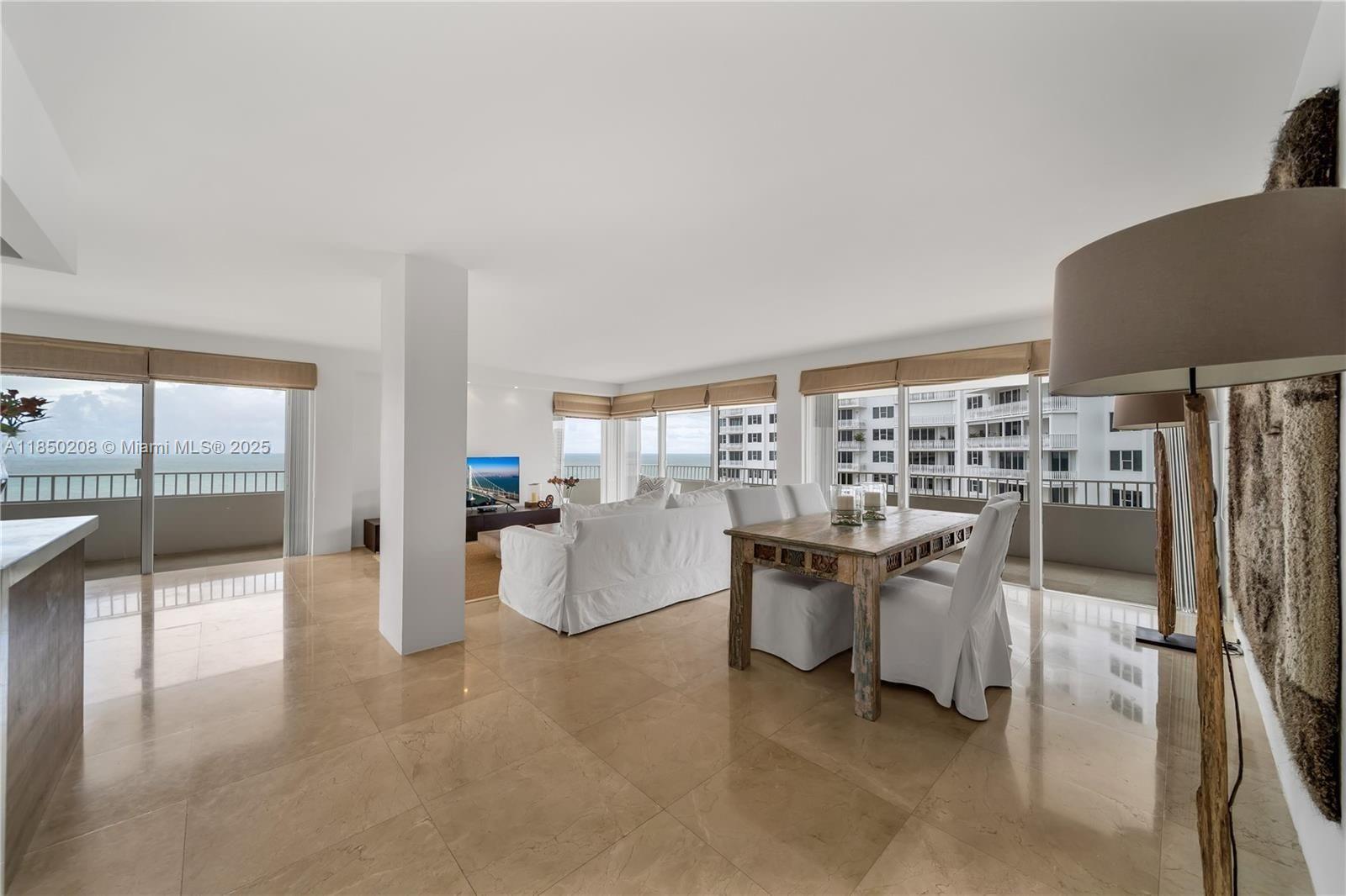 199 Ocean Ln Drive, Unit 901 Key Biscayne, FL 33149 - Photo 10 of 31 a dining room with furniture and a floor to ceiling window