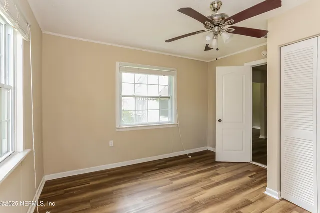 a view of a livingroom with a ceiling fan and window
