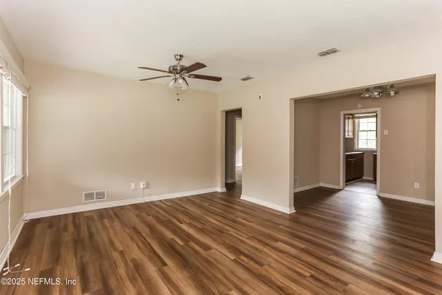 wooden floor in an empty room with a window