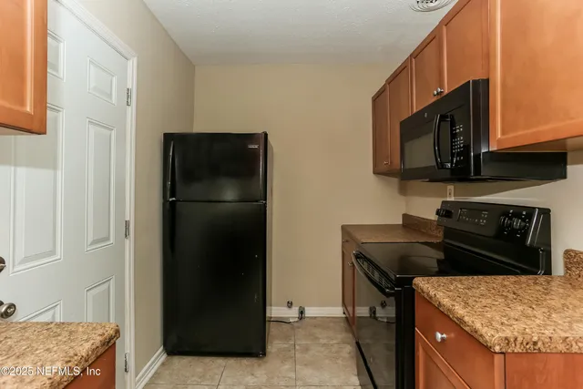 a kitchen with a refrigerator stove and microwave
