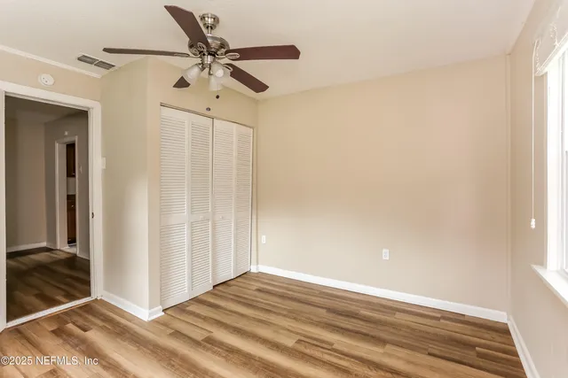 a view of a livingroom with a ceiling fan and window