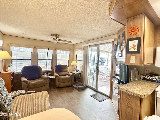 a living room with furniture and a large window with wooden floor