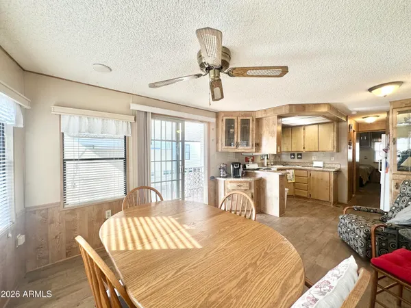 a kitchen that has a stove and a table chair in it