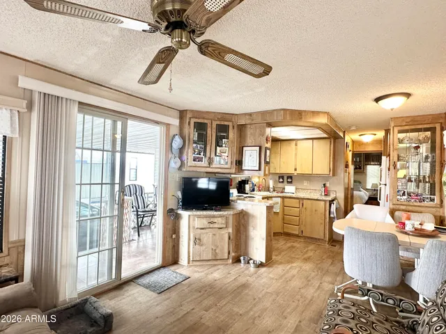 a kitchen with a stove a sink dishwasher and a refrigerator with wooden floor