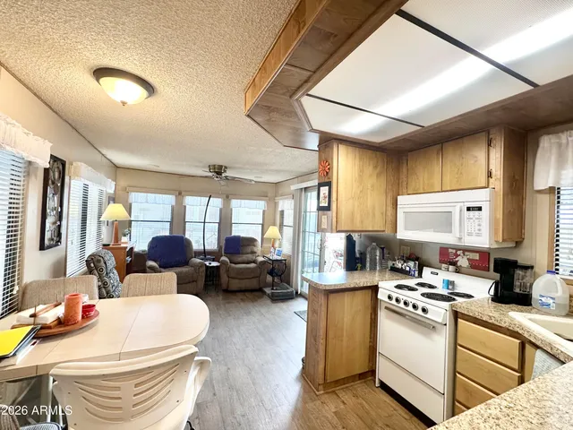a living room with furniture a rug and a table