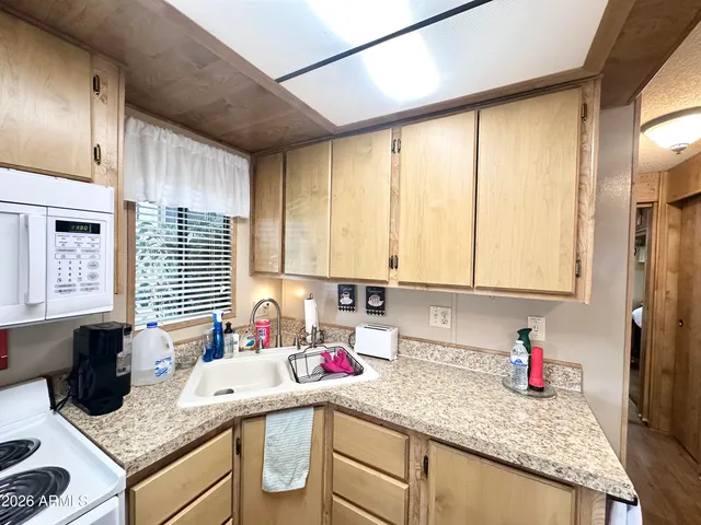 a living room with furniture a flat screen tv and a window