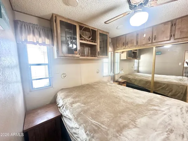 a living room with furniture a flat screen tv and a large window