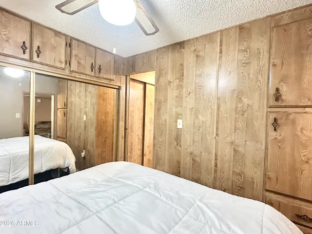 a front view of a house with a yard and tree s