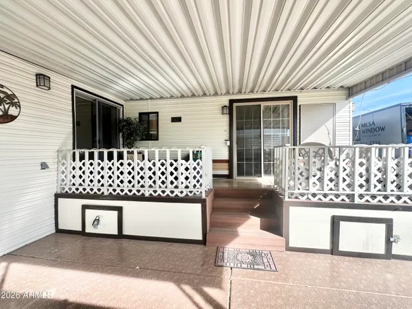 a view of a patio with table and chairs and wooden floor