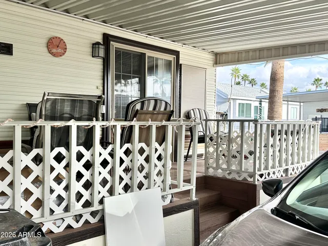 a view of a chairs and table in the back yard