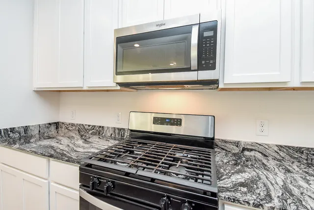 a kitchen with a stove and a microwave