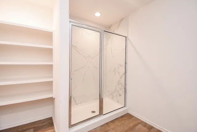 a bathroom with a glass shower door
