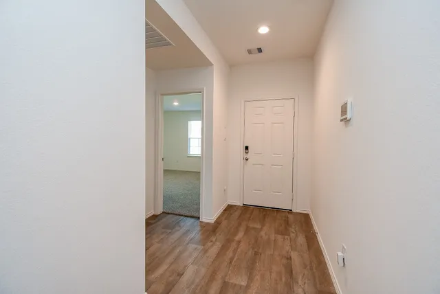 a view of a room with wooden floor