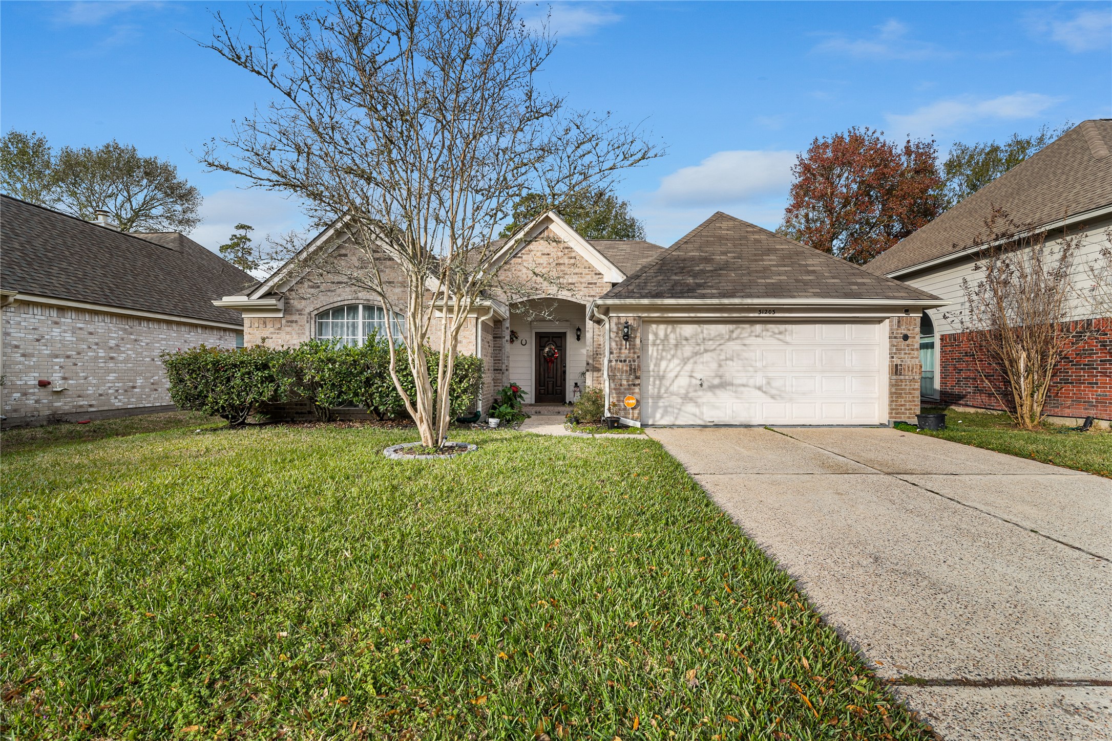 This beautifully maintained home features a classic traditional facade with a two door garage and a lush front yard that offers great curb appeal.