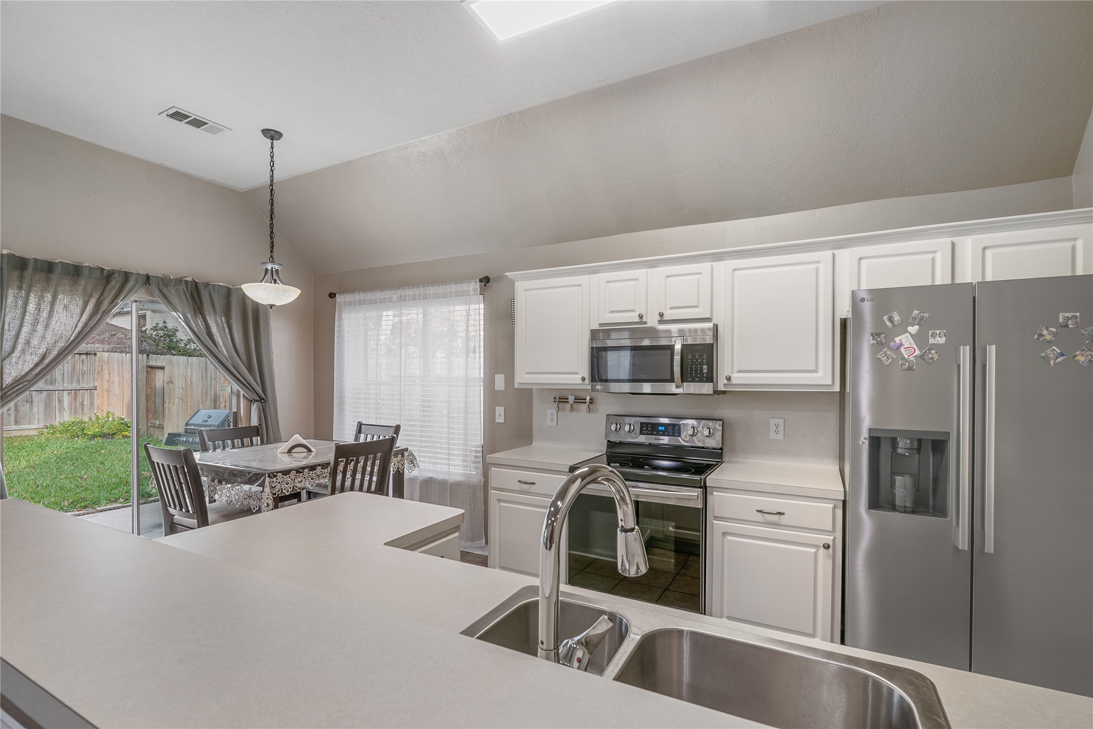 31203 Baker Lake Drive Spring, TX 77386 - Photo 12 of 24 Enjoy effortless meal prepping and memorable gatherings in this well-designed kitchen and nook combination, featuring stainless steel appliances, a double-sided refrigerator, and a functional layout that supports both everyday living and entertaining.