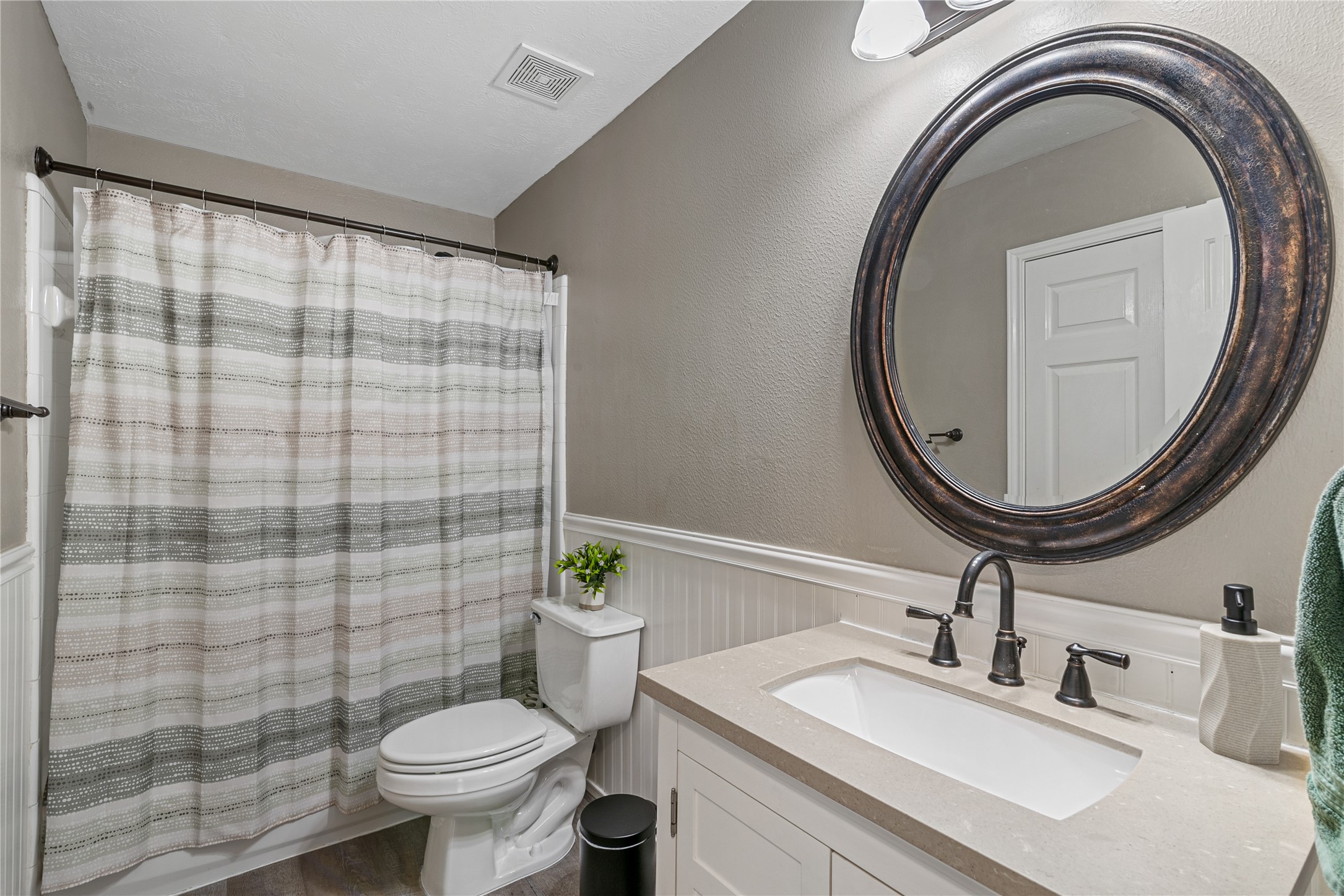 31203 Baker Lake Drive Spring, TX 77386 - Photo 14 of 24 This cozy full bathroom is conveniently located between the two secondary bedrooms and features two-tone neutral color palette with elegant molding details, creating a clean, timeless and inviting space.