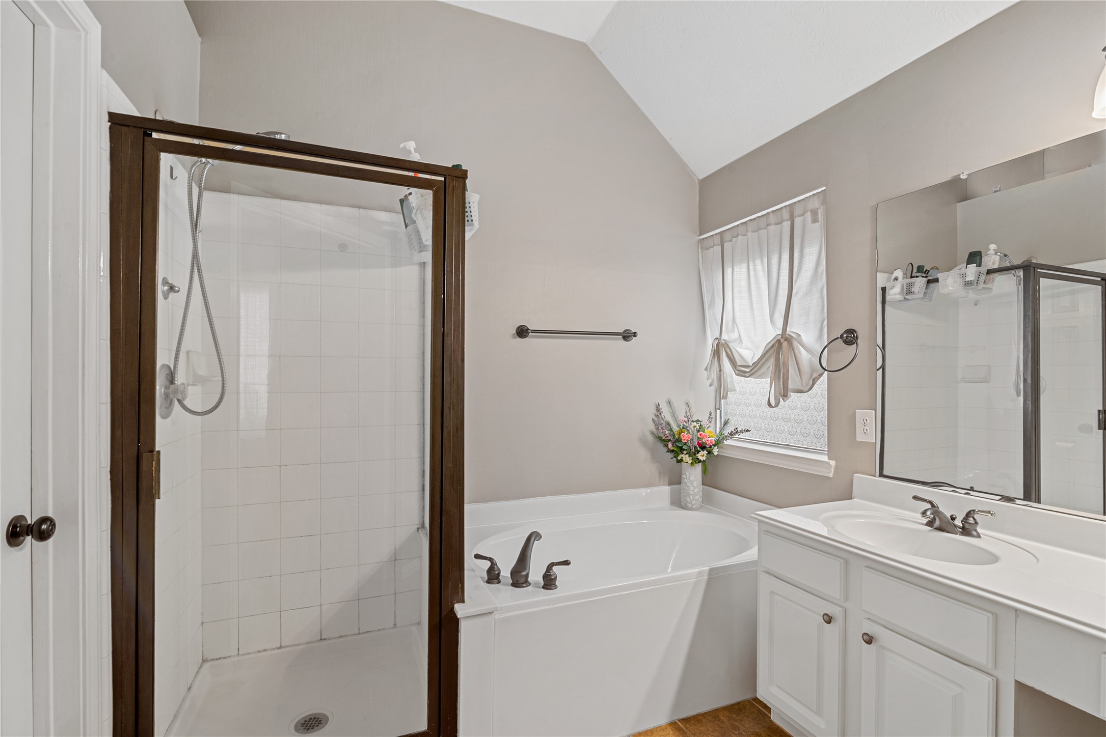 31203 Baker Lake Drive Spring, TX 77386 - Photo 17 of 24 The primary bathroom offers both a relaxing soaking tub and a seperate standing shower, providing exceptional functionality and everyday comfort. Natural light fills the space, enhancing its bright, serene and spa-like atmosphere.