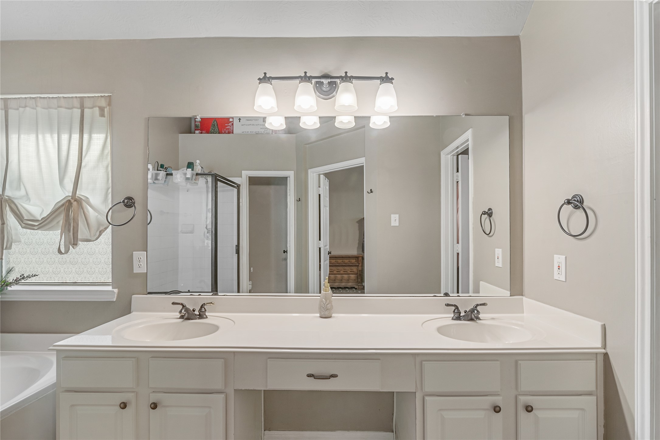 31203 Baker Lake Drive Spring, TX 77386 - Photo 18 of 24 The primary bathroom features a spacious double vanity along with dedicated makeup vanity, offering a highly functional and well-designed space that blends comfort and convenience for everyday routine.