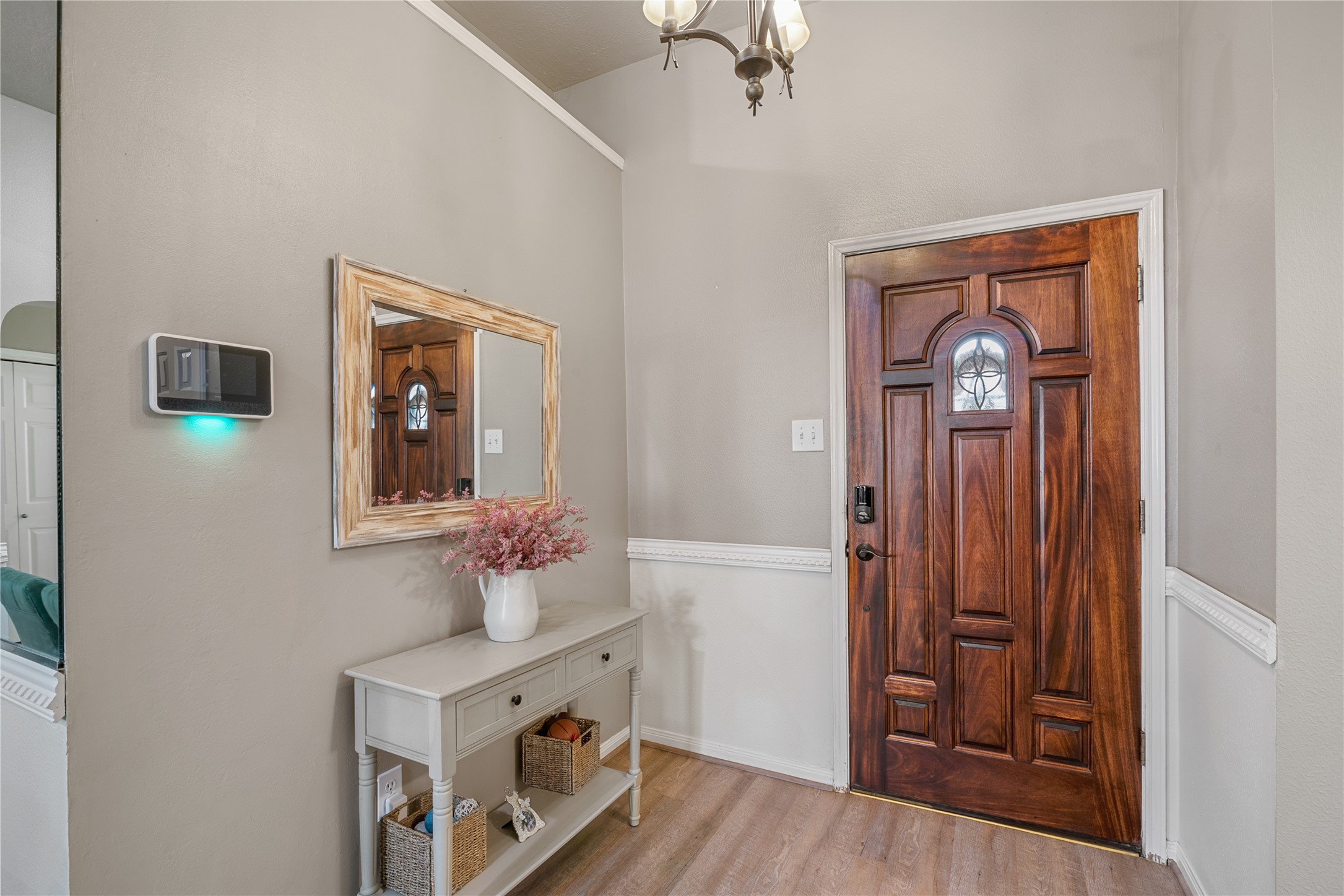 31203 Baker Lake Drive Spring, TX 77386 - Photo 4 of 24 Inviting foyer showcasing a two-tone neutral color palette that elegantly frames the front door and sets a refined tone upon entry.