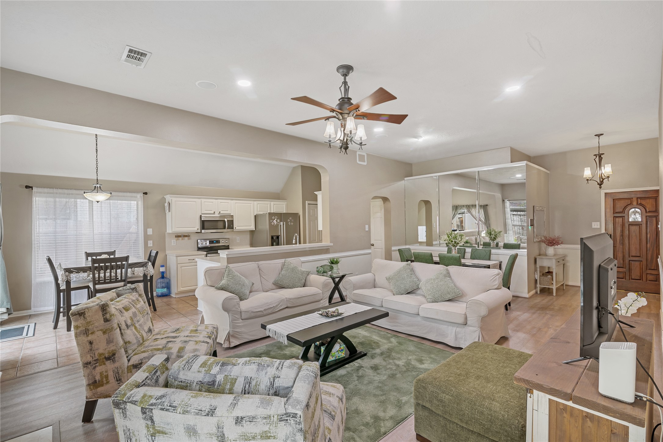 31203 Baker Lake Drive Spring, TX 77386 - Photo 9 of 24 This view highlights the seamless open-concept layout, effortlessly connecting the inviting entry, dining area, cozy breakfast nook, and well-appointed kitchen. The thoughtful flow creates a warm and welcoming atmosphere, ideal for both everyday living and entertaining. natural light enhances the space, showcasing the home's charm, functionality, and comfortable design.