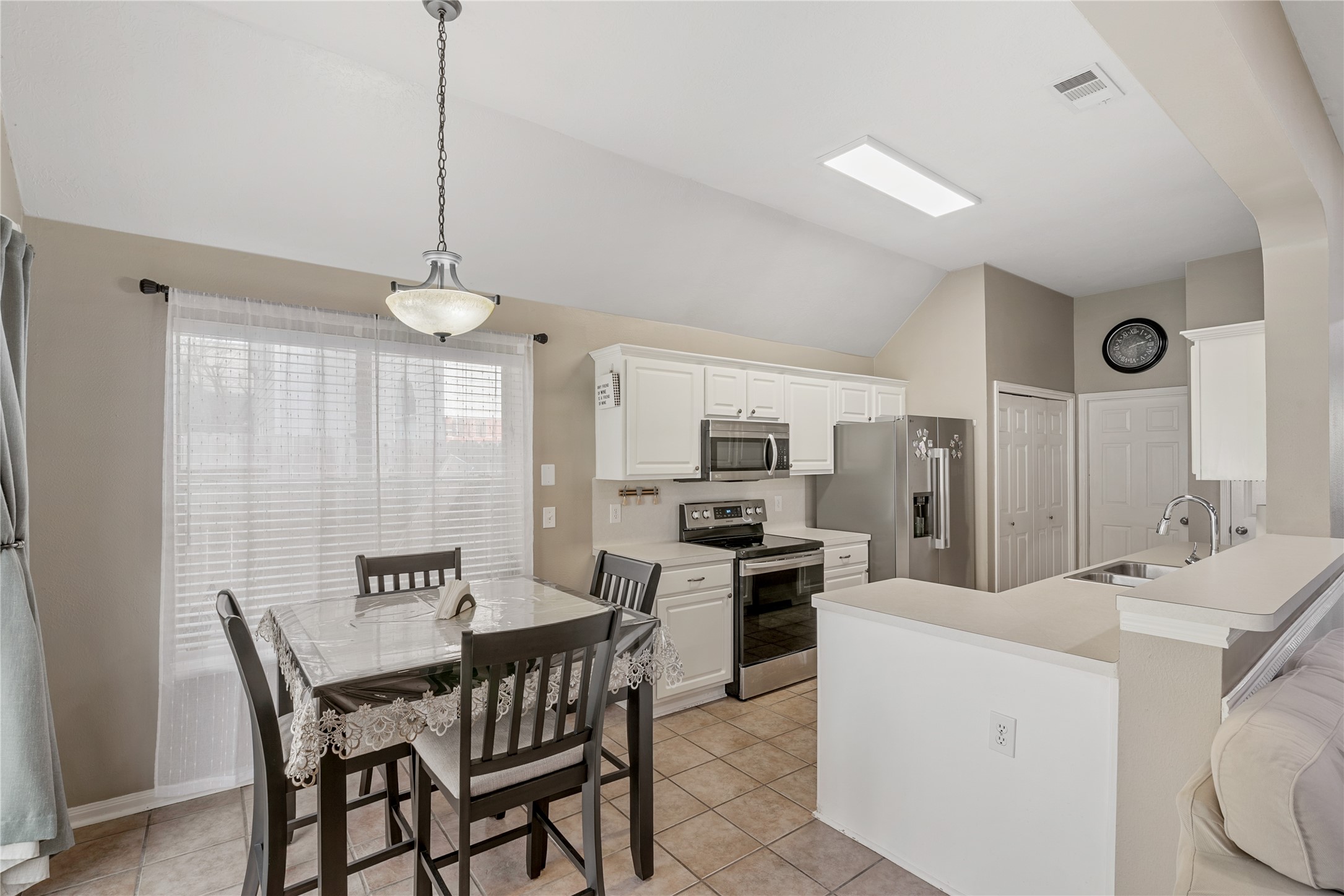 31203 Baker Lake Drive Spring, TX 77386 - Photo 10 of 24 The kitchen and breakfast nook offer a highly functional and well-designed space, featuring stainless steel appliances, ample counter space, and a practical layout ideal for daily use. Large windows flood the area with natural light, enhancing the open feel and creating a bright, welcoming environment for cooking, dining and gathering.