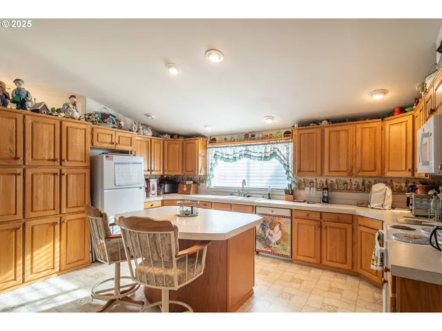 a kitchen with a sink stove and refrigerator