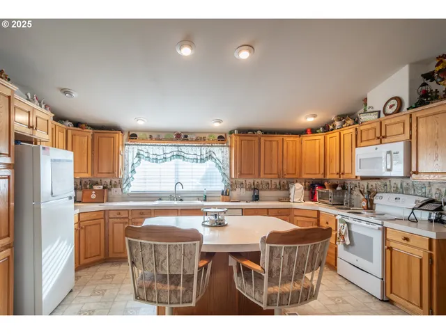 a kitchen with a table chairs stove and cabinets