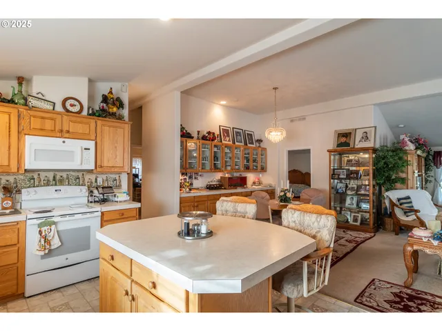 a living room with furniture a chandelier and a dining table
