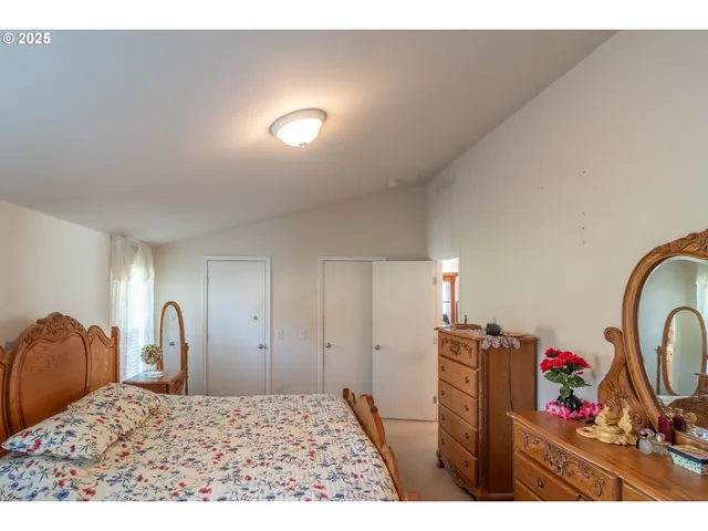 a bedroom with a bed and with furniture