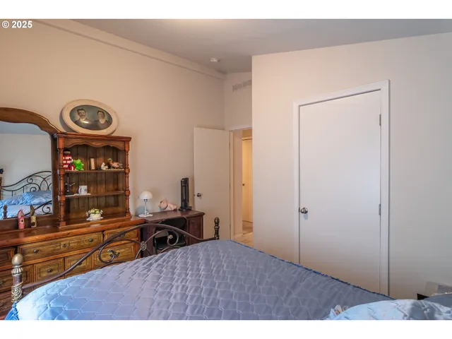 a bedroom with a bed and a dresser