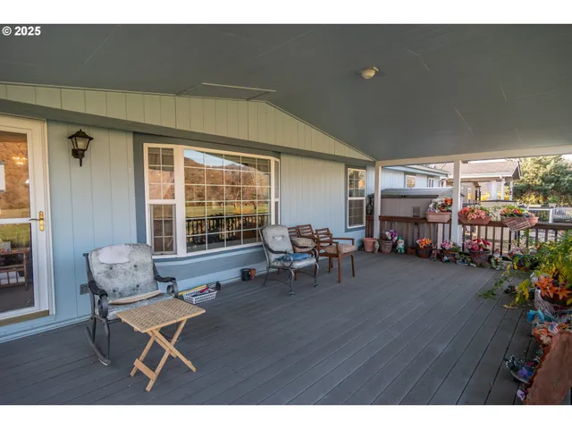 a view of balcony with wooden floor and outdoor seating