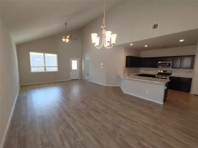 a view of kitchen with sink and wooden floor
