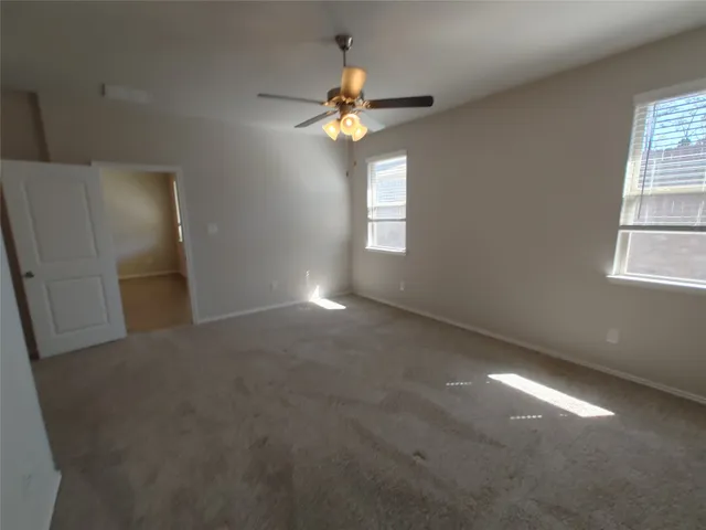 a view of a livingroom with a ceiling fan and window