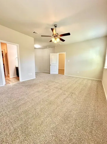 a view of a big room with closet and a ceiling fan