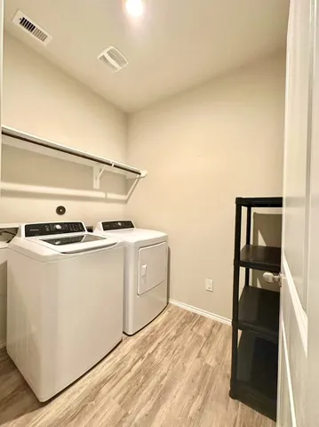a utility room with cabinets washer and dryer