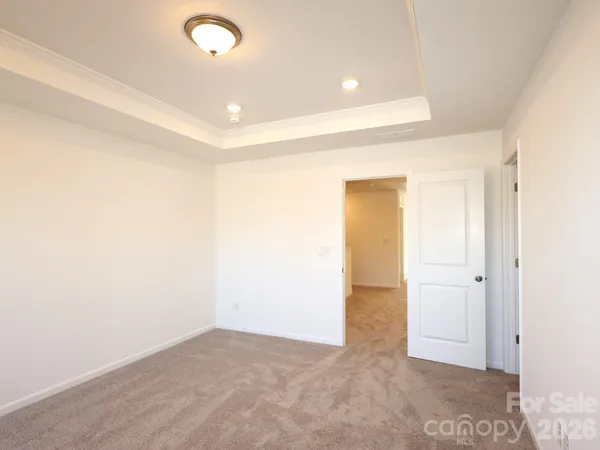 an empty room with closet and mirror
