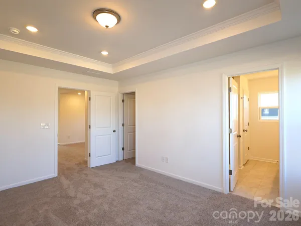 an empty room with closet and a bathroom
