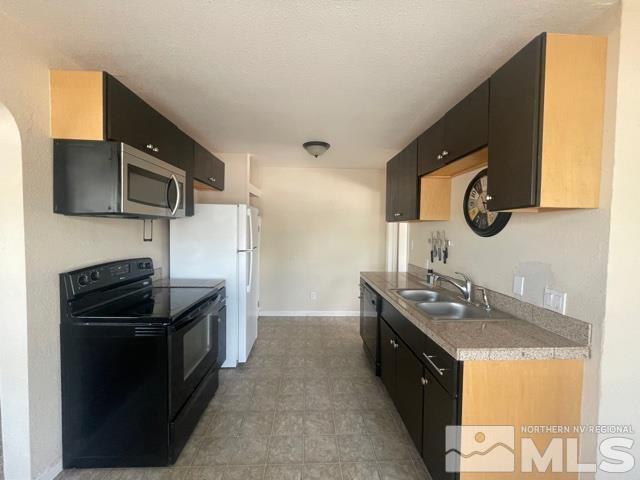 690 Cleveland Avenue Reno, NV 89503 - Photo 3 of 15 a kitchen with stainless steel appliances granite countertop a stove and a microwave