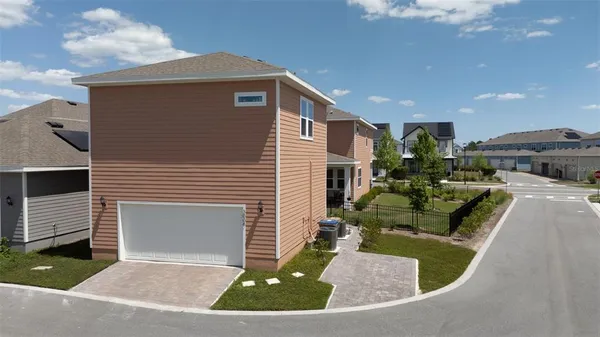 a view of a house with backyard and sitting area