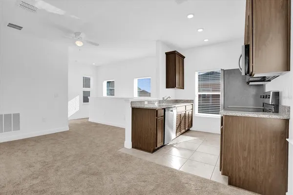 a large kitchen with a large counter top a sink and a stove