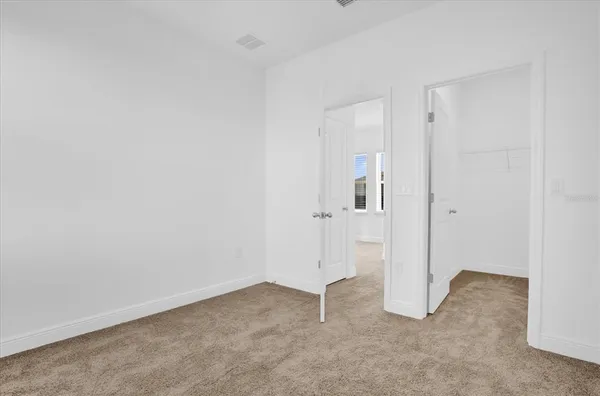 an empty room with closet area