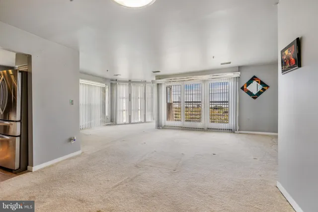 a view of a big room with closet and chandelier fan