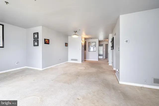 a view of a room with wooden floor and wardrobe