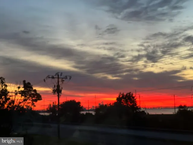 a view of a building with a yard and sitting area