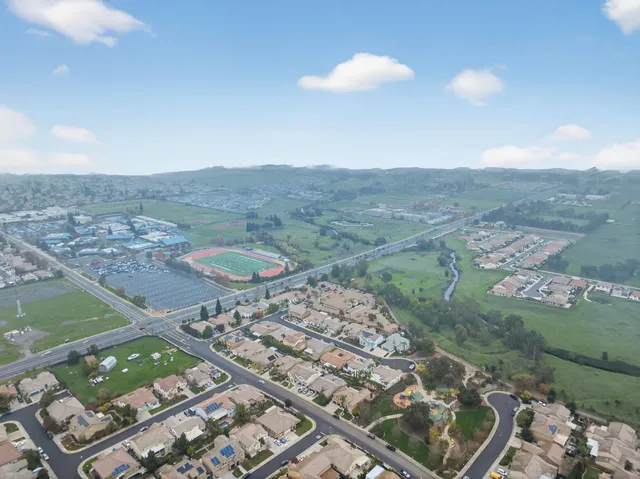 an aerial view of a houses with outdoor space and river