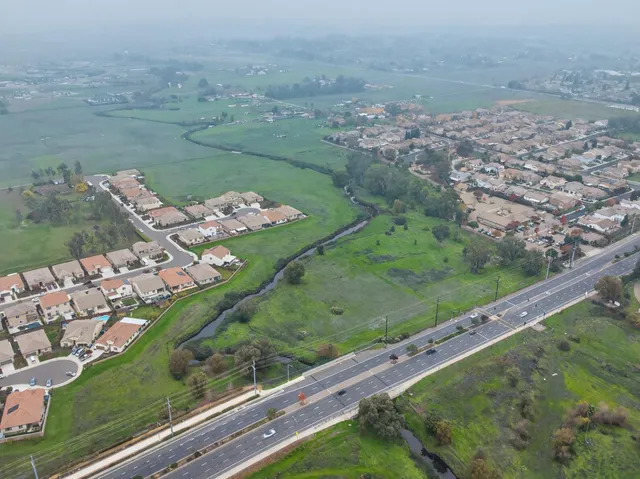 an aerial view of a residential houses with outdoor space