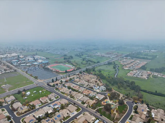 an aerial view of a house with outdoor space