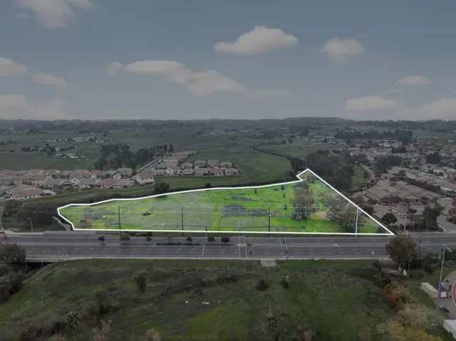 an aerial view of residential houses with outdoor space and river