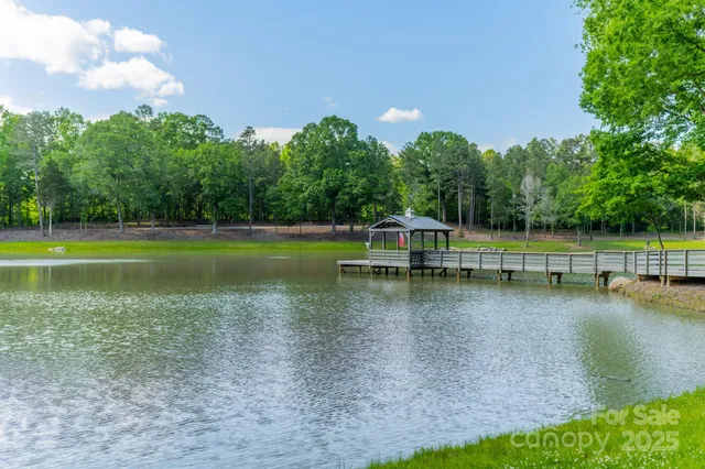 a view of a lake with a yard and trees