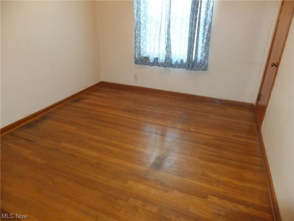 7701 Spring Garden Road Cleveland, OH 44129 - Photo 9 of 27 Empty room with wood-type flooring